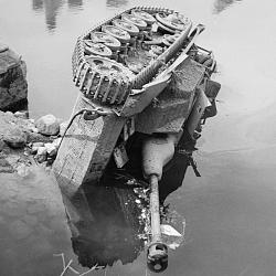 A German StuG III assault gun on its side in the river at Putanges, 20 (…)