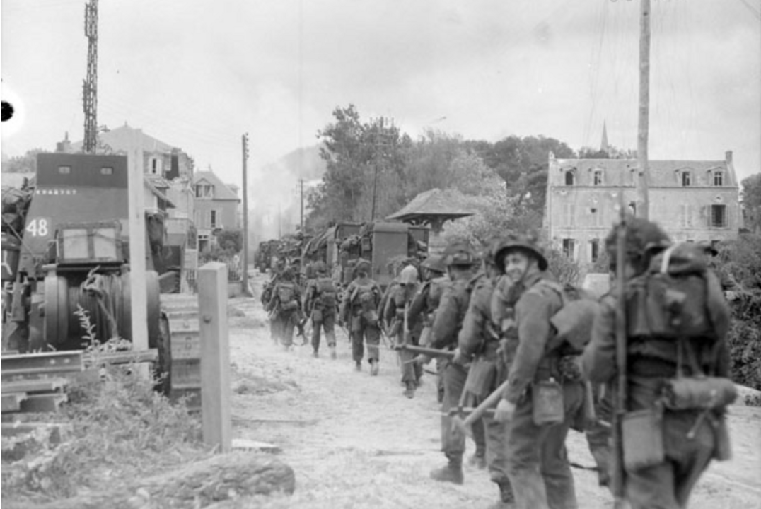 Infantrymen of Le Régiment de la Chaudière moving through Bernières-sur-Mer, France, 6 June 1944