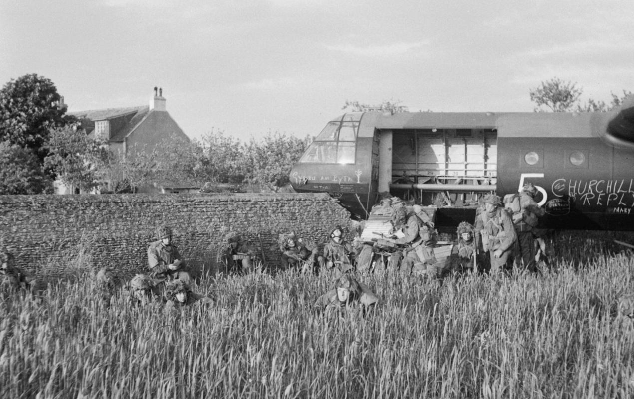 Glider troops of 6th Airborne Division beside their Horsa, which crashed through a stone wall on landing near La Haute Ecarde 