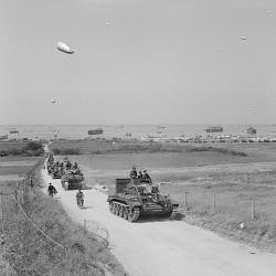 A Cromwell Mk V tank leads a column inland from King beach, Gold area, 7 (…)