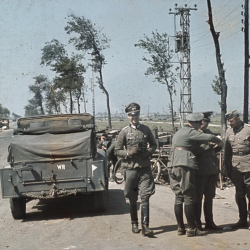On the outskirts of Dunkirk, German officers confer by their vehicles at the (…)