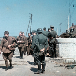 Disarmed French soldiers file pass German officers on the outskirts of Dunkirk