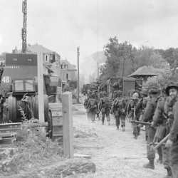 Infantrymen of Le Régiment de la Chaudière moving through Bernières-sur-Mer,