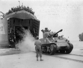  A French Army Sherman tank lands on a Normandy beach from USS LST-517, 2 August 1944