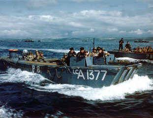 Royal Navy Landing Craft LCA-1377 carries American troops to a ship in a British port