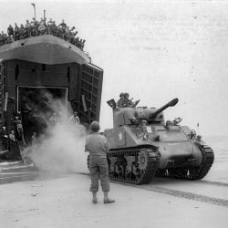 A French Army Sherman tank lands on a Normandy beach from USS LST-517, 2 (...)