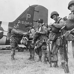US paratroopers check their kit before boarding for France